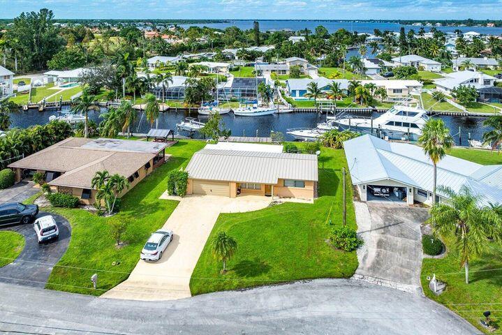 Experience the luxury of waterfront Florida living! This 3 bed 2 bath home features a private dock situated on a deep water canal. No fixed bridges making the 30 minute ride from the dock to the inlet a breeze! 10 minutes down the intracoastal brings you waterfront dining options in Downtown Stuart to enjoy during a night out on the water. Access to private community boat ramp included! This home features a new updated kitchen and appliances including washer and dryer.