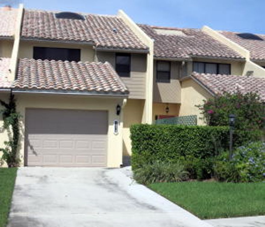 Fabulous remodeled townhouse with garage in one of the best, centrally located neighborhoods in Wellington with serene water view. This fully updated and gorgeous home features a brand new kitchen, neutral large-format tiles throughout lower level, spacious dining room, breakfast nook and family room with slider to private brick patio. Upstairs, elegant dark laminate flooring throughout the spacious secondary bedroom with bath and into the huge Master Suite with very large walk-in closet and  slider to large balcony with water view. Beautiful, newly remodeled baths. Community pool close by. Walking distance to library, town center, and amphitheater for movie nights, tribute bands, food truck invasion and more! Close to showgrounds, shopping, great restaurants. Hurry!