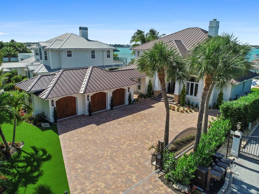 Nestled along the serene, bright blue waters of the Loxahatchee River lies this beautifully crafted completely renovated custom home built on .37 acres. This oversized home-site features panoramic views of the Loxahatchee River and is just a few minutes to Jupiter's waterfront restaurants and the Jupiter Inlet. Attention to detail was paramount in constructing this concrete block home with hurricane impact windows entry doors and a new standing seam metal roof.

Outside enjoy sunsets from the comfort of your luxurious tiki hut equipped with TV, beverage center and an outside bar. After a long day on the boat, relax in the low maintenance synthetic turf backyard or swim in your professionally designed heated pool and spa with fiber optic lighting. Hone your putting skills on the professionally installed putting green.

For the boating and fishing enthusiast, the private dock features two boat lifts and fresh water and electric at the Epay wood planked dock. A 25-kw Generator will operate the ACs and appliances.

Inside you will find handcrafted hardwood floors in the main living areas, custom wood shaker style maple cabinets in the open kitchen, granite and quartz countertops with a mitred edge and professional series Thermador stainless steel appliances. The trim package is better than most homes twice this price point with custom built-ins in the great room, study and custom millwork in the master and guest bedrooms. The 2nd floor master suite features outstanding interior design details and a breathtaking view that will make you wonder why it took so long to find this gem. In the master bathroom, you'll find a luxurious spa-inspired design with an oversized frameless glass shower, double vanities, custom wood cabinetry and exotic granite vanity tops and matching shower and bath tiles. All closets come with wonderfully designed handcrafted built-ins for clothing, accessories and shoes. The guest suites are ample, cozy and warm, all with walk-in closets and en-suite baths. This home will not disappoint anyone in this price range.

This is Jupiter Waterfront Living...Perfected.