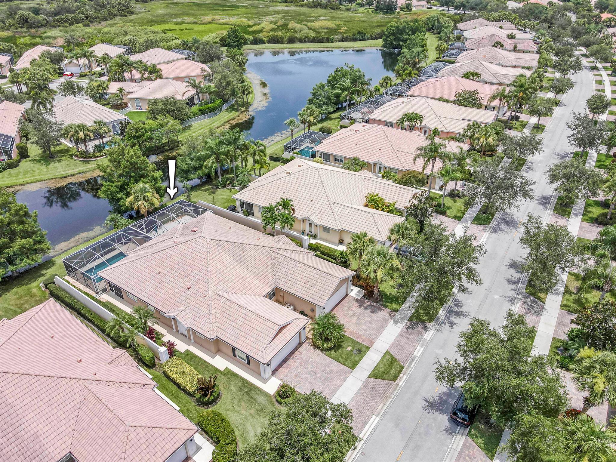 Meticulously maintained 2/2 lakefront villa in the desirable DiVosta built community, The Lakes at Tradition. This villa features an oversized screen patio with long sweeping views of the gorgeous lake. This extended model boasts an open floor plan and has two private bedroom suites with walk in closets. The kitchen features 42' cabinets with corian counters and tile backsplash. Some of the many other features of this home include: tile flooring throughout with exception of bedrooms which have laminate flooring, barrel tile roof, paver driveway, plantation shutters, updated primary bathroom, central vacuum, walk in closets with built-in shelving, plus much more. The community amenities include: recreational facilities, clubhouse, lighted tennis courts and pickleball courts