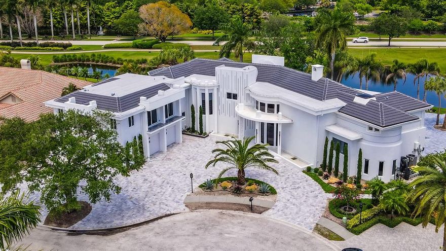 For the most discerning of clients...  Newly rebuilt 10BR, 14bath, 5.5 car garage + office, game room, theater/media rm & elevator to 2nd level. This double lot pool home (Cul-de sac) w panoramic lake & golf vistas boasts a complete attached 3/3 guest house. Floors throughout are 8'' wide solid walnut, 12' dramatic front doors & 10' doors throughout.  3 full kitchens, Huns Krug soft close European imported cabinets, elegant marble countertops, luxury Italian made faucets, Sub-Zero ref/freezer, built in coffee maker, butler's kitchen, gas stoves, 2 tankless hot water heaters, heated pool & jacuzzi, full house generator, theater, open loft areas, private office, built in safe, Bose/Yamaha surround sound, security cameras, new concrete tile roof, SIW impact windows w lifetime warrantee.