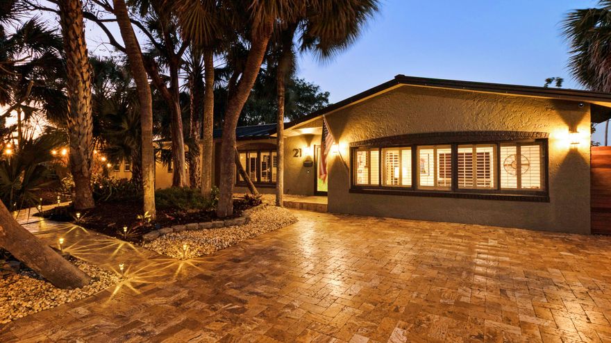 Welcome to this elegantly upgraded 3-bedroom, 2-full-bath Waterfront retreat in Cypress Harbor, offering the perfect blend of privacy, modern comfort, and South Florida outdoor living. With NEW ROOF. Set on a lush, oversized lot with a designated wildlife sanctuary and tranquil pond, this home delivers exceptional curb appeal and serene natural surroundings. Enjoy 80 feet of water frontage with a 70-foot dock at the end of the canal, ideal for boating and waterfront relaxation. Southern exposure fills the home with natural light, while a Tigerwood hardwood deck with steel cable railing provides stunning water views.
Inside, porcelain white tile floors (2023) flow throughout, complemented by custom wood accents including wainscoting, ceiling beams, and a chevron feature wall in the dayroom. The kitchen offers granite countertops with bar seating and brand-new Samsung appliances (2023). Both bathrooms were fully remodeled in 2023, highlighted by a heavy-glass walk-in rain shower in the primary suite. Every bedroom features walk-in closets with sliding door access to the backyard in the primary and third bedroom. Additional conveniences include a LARGE laundry room/PANTRY, cabana bath with tub/shower combo, Bahama shutters, IMPACT WINDOWS AND DOORS, Springwell water purification system with softener, NEW hot water heater (2023), and a newer A/C system with Nest thermostat (2021).
The backyard is an entertainer's dream, featuring a refinished deep-blue saltwater pool (2023) with NEW pump and Dolphin vacuum, outdoor shower, fire pit, covered 10' x 40' patio with generous seating, grill area with future bar potential, travertine pavers, hardwood gates and fencing, custom built animal enclosure, and a large 8' x 12' storage shed. The front yard also features an oversized travertine driveway offering ample space for yourself and guests. A new metal roof (2023) and full landscaping create exceptional privacy and peace of mind. 
Pompano Beach is one of South Florida's fastest-growing coastal communities, offering an elevated blend of Waterfront lifestyle, convenience, and long-term investment appeal. The revitalized beachfront offers world-class restaurants and luxury destinations including The W, Ritz-Carlton, and Waldorf Astoria. Enjoy the Pompano Beach lifestyle with an abundance of rooftop lounges, casual oceanfront dining, the iconic fishing pier, and new waterfront parks designed for an active, outdoor lifestyle.
Downtown continues to evolve with the completion of the new City Hall and expanded civic spaces, while walkable neighborhoods and the Circuit electric rideshare make getting around easy and efficient. With quick access to intracoastal waterways and ocean access just minutes away, Pompano Beach is a boater's dream community. Local pickleball courts, neighborhood parks, and multiple championship golf courses throughout the area are the cherry on top. For travelers and commuters, you'll have easy access to US-1 and I-95. FLL Int'l Airport is 20 minutes away, Miami Int'l Airport is 45 minutes away, and Palm Beach International Airport is 40 minutes away.
