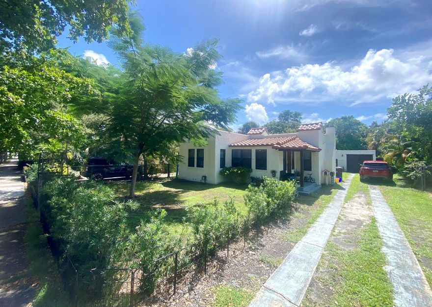 Discover this charming multi-building property on beautiful Upland Road in vibrant Pineapple Park, West Palm Beach. Featuring two separate residences, each with its own unique character, this property offers flexibility for multi-generational living or rental income. The back cottage is currently rented for $1,800/month and had 6 months remaining on the lease. The front home is a 2-bedroom, 1-bath with a front Florida room, and the rear home is a 1-bedroom, 1-bath. Both feature new roofs (2024) and updated PVC plumbing. Inside, you'll find bright, well-maintained spaces with thoughtfully updated interiors. The kitchen has been newly updated with wood cabinetry and integrated lighting, and the bathroom is newly updated as well. New impact