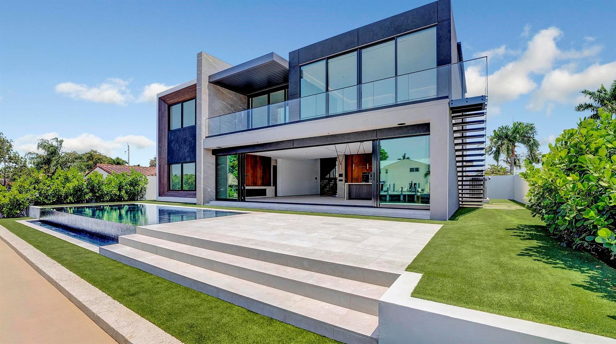It was all a dream! Brand new construction with every bell and whistle you can dream of. Step through the pivot
front door to a jaw dropping floating staircase, earthy tones, good energy, clean lines, this waterfront 5 bed, 5.5
bath is a true showstopper. The custom kitchen has Wolf & Jenn Air appliances, Taj Marble counters, wine and liquor
cabinets! The kitchen opens to the living room with Italian oak paneled walls, a fireplace with expansive 33’ of floor
to ceiling glass with a view of the pool and canal. The primary suite has custom closets and a bath like you have
never seen before, floating cabinets, towel warmers and even an Apple TV in the mirror. Mosaic tile infinity pool, turf
yard, glass panels the list goes on. The house is 100% smart with IPADS in each room.