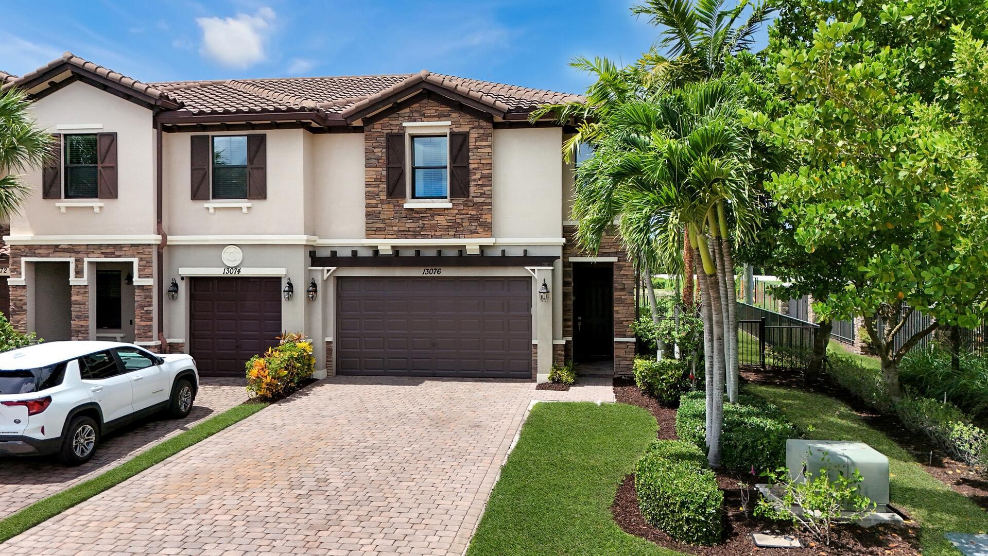 Discover this stunning 4-bedroom, 3.5-bath end-unit townhouse offering modern upgrades and an ideal blend of style and comfort. Impact windows provide peace of mind, while wood-look tile flooring on the first floor and brand-new carpeting upstairs create a fresh, welcoming feel. Elegant custom window coverings, high hat lighting, and a wrought iron staircase add to the home's sophisticated design. The open-concept kitchen is a chef's delight, featuring granite countertops, a full granite backsplash, wood cabinetry, stainless steel appliances, a pantry, and a convenient snack bar. The spacious primary suite boasts a tray ceiling, walk-in closet, and a spa-like bath with dual granite-topped sinks, a soaking tub, and a walk-in shower.