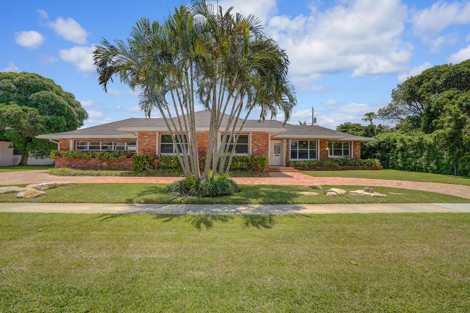 Experience lakefront living with this beautifully renovated home overlooking 540 acres of serene Lake Magnolia. Enjoy stunning waterfront and pool views from the kitchen, living room, and primary bedroom. This home has been thoughtfully updated with all new flooring, a new roof, tankless water heater, plumbing, air conditioning, hurricane shutters, modern lighting, ceiling fans throughout, and new bathrooms. The spacious primary suite features a luxurious soaking tub and generous storage space. Outdoor enthusiasts will love kayaking right from their backyard. Additional features include a large two-car garage with washer and dryer, ample storage, a paver circle driveway, exterior lighting, and cameras. Located just minutes from downtown West Palm and the airport.