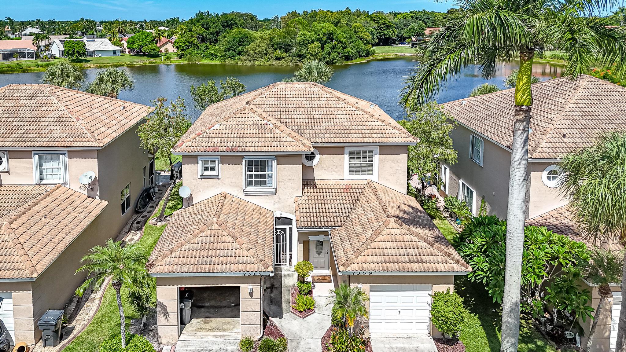 Lakefront Living | A-Rated School District | Highly Desirable Smithbrooke | Meticulously Maintained | Newer A/C, Water Heater and Washer/Dryer | Bright Open Floor Plan | Spacious Living and Dining Areas with Half Bath | Kitchen Boasts Granite Counters, Custom Tile Backsplash, Stainless Appliances and Barstool Seating | Covered Extended Patio Overlooking Serene Lake and Oversized Yard -- Perfect for Entertaining | Primary Suite with Lake Views, Large Walk-In Closet and Ensuite Bath with Dual-Sink Vanity and Frameless Shower | Guest Suite with Ensuite Bath and Shower/Tub Combo | Family-Friendly Gated Neighborhood | Community Pool, Fitness Center & Racquetball | Can Rent Immediately | Prime Location Near Beach, Dining, Shopping and Wellington Equestrian Center | ROOF 1998 | AC 2022 | WH 2022