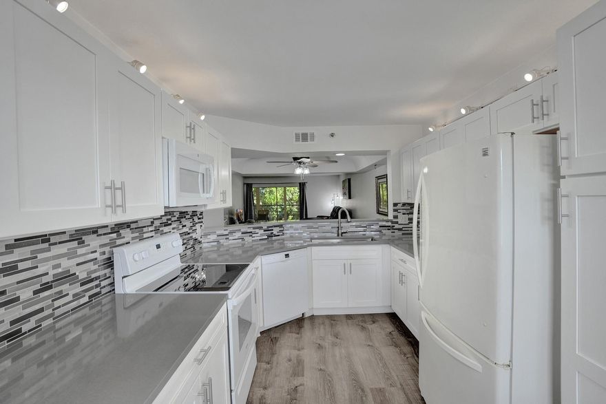 Welcome to this beautifully remodeled 2-bedroom, 2-bathroom condo at Pines of Boca Barwood, a quiet 55+ community offering a sparkling community pool, tennis courts & convenient elevator taking you to your 4th floor unit. Step into a brand-new kitchen featuring sleek countertops, a contemporary backsplash, and white shaker cabinets. Both bathrooms have been tastefully remodeled, and waterproof laminate wood floors flow throughout the unit. Enjoy the convenience of an in-unit washer and dryer and accordion shutters for added peace of mind. Relax on the large screened-in balcony with storage closet. 1 covered Carport Parking space right in front. Located near 441, golf courses, shopping, dining, and entertainment, this condo offers the perfect blend of comfort and convenience. Don't miss out