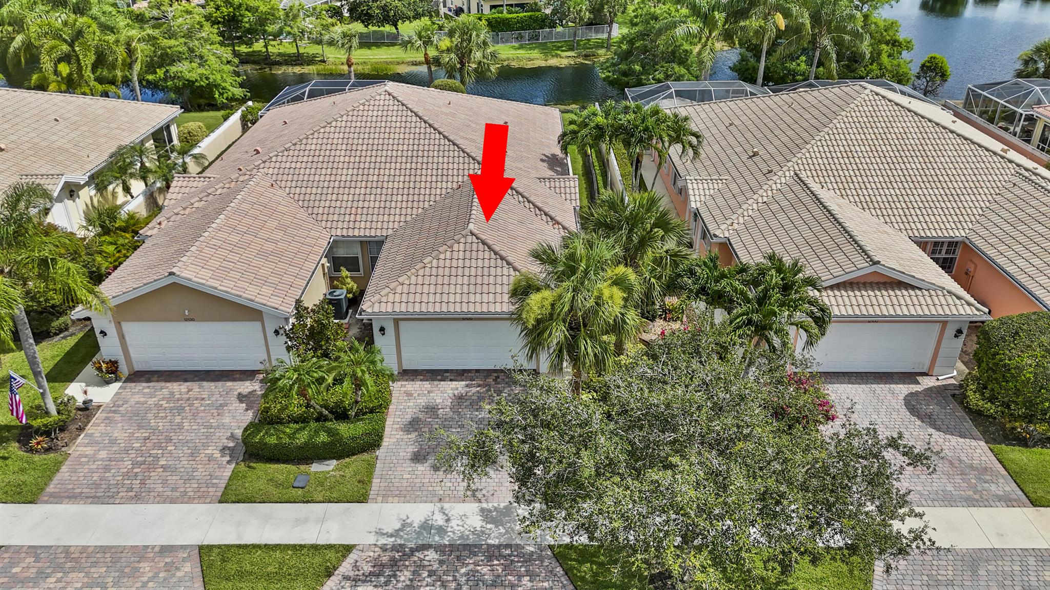 NEW LISTING AVAILABLE TO SHOW JULY 8. An amazing rare opportunity, stunning water view, tile roof, 2-bedroom, 2-baths, concrete block home with a spacious 2-car garage and gorgeous lake views from the expansive screened-in back porch.Step inside to a bright, split floor plan designed for modern living. The tile flooring in living areas creates a sleek, clean look, the kitchen has beautiful Corian countertops and plenty of cabinets, laundry room inside with closet space.Fabulous lake view from the master bedroom, while the large walk-in closets and double sinks in the master bath add both comfort and style. Equipped with a central vacuum system with suction outlets in every room, making daily maintenance a breeze, electric water heater installed in 2024.Enjoy a resort-style life,