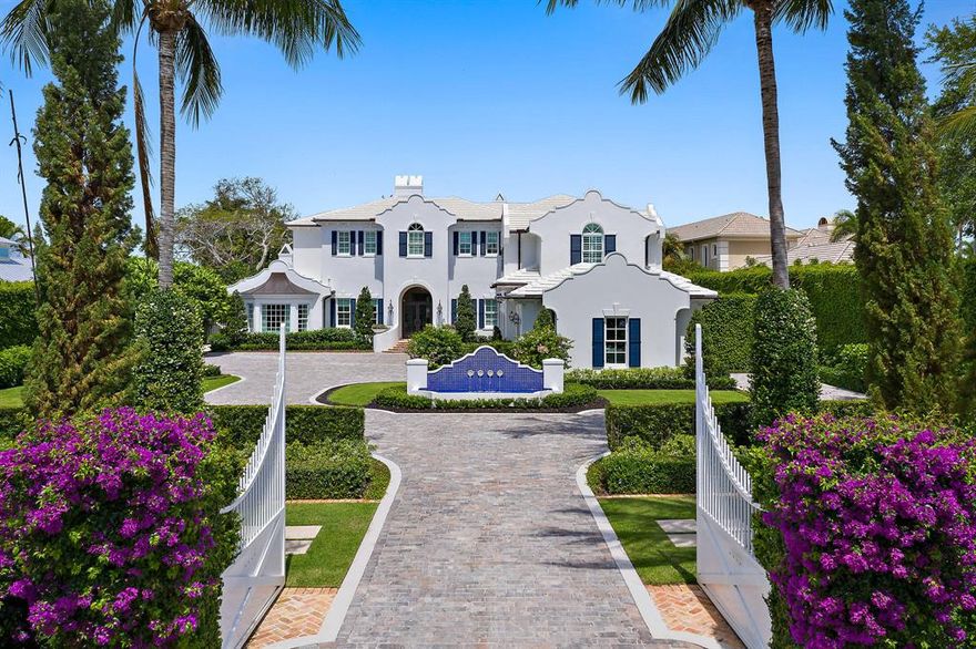Unrivaled craftsmanship is consistent throughout every inch of this breathtaking, riverfront estate. Its Dutch Colonial architecture separates this home from all the others with high-end finishes & amenities such as: imported European marble & hardwood floors; elevator; 5 gas fireplaces; state-of-the-art sound system throughout (plus 7 large flat screen TV's); media room with projection TV & 7 automated theater seats; gourmet kitchen with Calcutta Gold center island, Sub-Zero refrigerators & 60'' Wolf stove; butler's pantry with Carrera marble counter & sink, separate ice maker and wine closet; and grand, gated entry with decorative, cobblestone pavers that lead to a choice of 4 garages. Its outdoor living area is unmatched and boasts a spacious loggia, outdoor dining area, summer kitchen & sun deck, meticulously maintained backyard, salt water pool & with 100 ft. of water frontage, long views of the north fork of the "wild & scenic" Loxahatchee River. The private dock with 2 lifts puts you just minutes away from the Jupiter Inlet. This well built & appointed home is a rare find like no other!
