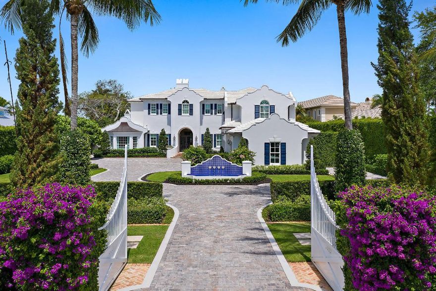 Unrivaled craftsmanship is consistent throughout every inch of this breathtaking, riverfront estate. Its Dutch Colonial architecture separates this home from all the others with high-end finishes & amenities such as: imported European marble & hardwood floors; elevator; 5 gas fireplaces; state-of-the-art sound system throughout (plus 7 large flat screen TV's); media room with projection TV & 7 automated theater seats; gourmet kitchen with Calcutta Gold center island, Sub-Zero refrigerators & 60'' Wolf stove; butler's pantry with Carrera marble counter & sink, separate ice maker and wine closet; and grand, gated entry with decorative, cobblestone pavers that lead to a choice of 4 garages. Its outdoor living area is unmatched and boasts a spacious loggia, outdoor dining area, summer kitchen & sun deck, meticulously maintained backyard, salt water pool & with 100 ft. of water frontage, long views of the north fork of the "wild & scenic" Loxahatchee River. The private dock with 2 lifts puts you just minutes away from the Jupiter Inlet. This well built & appointed home is a rare find like no other!