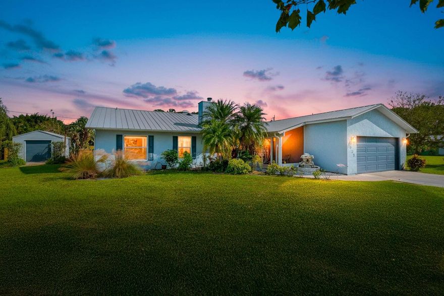 Rare double-lot estate offering luxury finishes, exceptional privacy, & true indoor-outdoor living. This home features a METAL ROOF, stunning strand bamboo/slate tile floors, wood cabinets/crown molding, & a beautiful stone wood-burning fireplace that adds charm throughout. The outdoor space is an Entertainer's dream with a large covered patio, Bose surround sound, hot tub & pool, young fruit trees (Barbados Cherry, Avocado, Mulberry, & Mango), and a spacious yard with a dedicated fenced area ideal for pets or play. A powered workshop shed offers the perfect space for hobbies or a home business. Homes with this level of land, craftsmanship, and entertainment potential are incredibly rare. Don't miss your chance to experience this one-of-a-kind property