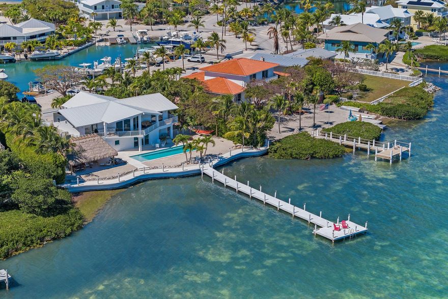 A Historic Legacy in the Heart of the Middle Keys. 347 Stirrup Key Blvd, a masterpiece of Florida Keys living. Designed by the visionary behind Stirrup Key, this waterfront sanctuary offers breathtaking Gulf views, a deeded marina slip, & the privacy of a rare gated community. Inside, native pine ceilings blend old-world charm with modern luxury. With 4beds & 3baths, each with breathtaking water views, creating a seamless blend of indoor-outdoor living. Recent updates include a metal roof, impact glass, & a whole-home 36KW generator. The heated pool with a tanning ledge & Endless Swimming System is complemented by a grand tiki hut overlooking the open water. Convenient to Marathon’s International airport, world-class dining, & premier fishing, this estate is more than a home—it’s a legacy.