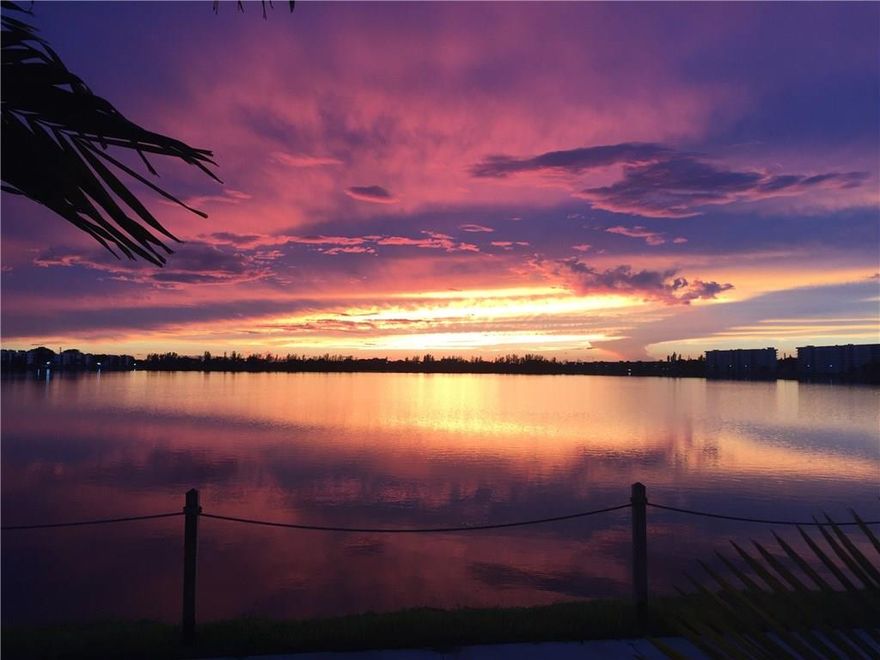 This is the largest unit in Lake Emerald!  It is also the best location - next to clubhouse & main pool area! Direct lakefront 2/2 corner unit has a 32 ft. long screened balcony, and expanded water views from all rooms! Open kitchen, large living room.  Master bath has dual sinks. COVERED PARKING!!!  24 hr. gated resort-like community has 3 heated pools & spas, tennis cts., fitness center. Premium cable tv incl in condo fee.  2 sm pets OK.  You'll be amazed at the lake and sunset views.