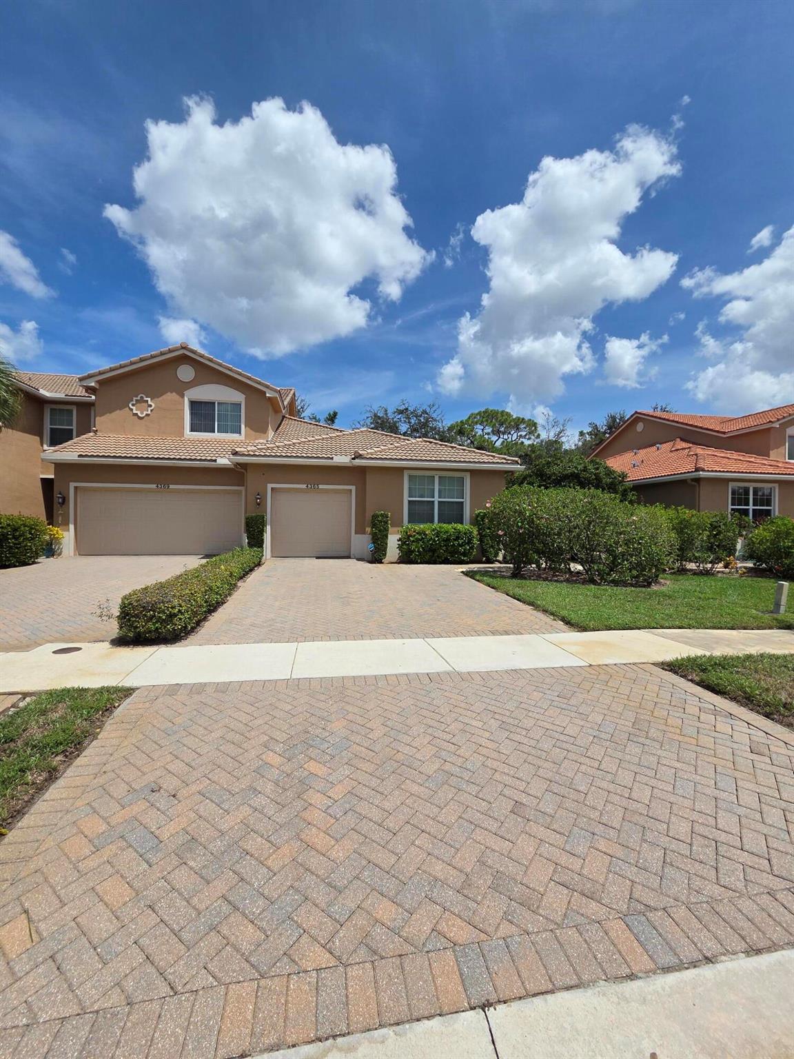 Discover this stylish 2-bedroom, 2-bath villa with a private garage, perfectly situated in a peaceful gated community close to all of life's conveniences. This end-unit home is filled with natural light and thoughtfully upgraded, featuring sleek tile and laminate flooring, an open kitchen with plenty of storage, impact windows and sliders, elegant tray ceilings in the primary suite, modern glass-enclosed showers, and crown molding that adds a polished touch throughout. A double driveway offers the kind of everyday practicality you'll appreciate. Step outside to your own brick-paved patio, an inviting spot to sip your morning coffee, relax after a long day, or entertain friends. As a bonus, you'll often see peacocks strolling through the community--a rare and peaceful backdrop.