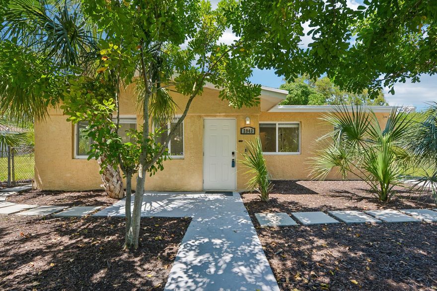 Nestled among old-growth trees with a peaceful lake backdrop and no neighbors on either side, this completely rebuilt 3-bed + den/bonus room, 2-bath retreat offers effortless South Florida living with true peace of mind. All major work permitted in 2025: full electrical rewire, new roof (10-yr warranty) & impact windows & doors (lifetime transferable warranty). Brand-new A/C (5-yr warranty) & premium insulation keep you cool year-round. Modern kitchen with white shaker cabinetry, quartz counters & brand-new stainless appliances. Luxury vinyl plank flooring, 2 remodeled bathrooms, matte black fixtures, recessed lighting & smart home technology throughout. Room for a pool, fully fenced yard, I-95 access & 15 min to downtown Fort Lauderdale.