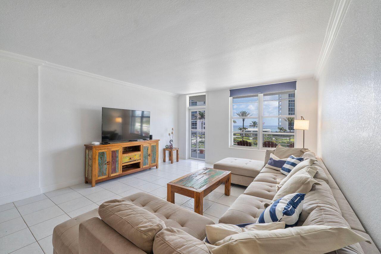 Enjoy ocean views from the comfort of your own home, thanks to the prime corner location of this bright and spacious unit. This split floorplan condo features tile floors throughout and hurricane impact windows for security and peace of mind. The unit is fully furnished with tasteful decor that complements the beachside setting, making it truly ready to live in the moment you walk through the door. Enjoy a beautifully landscaped pool, well-equipped fitness center, and the convenience of cable, Internet, and a cost-saving cooling tower included in your monthly maintenance. A short drive to Downtown Boca Raton and just one mile from the Deerfield Beach pier and boardwalk, plus shops and restaurants, this home offers the perfect blend of comfort, style, and location.