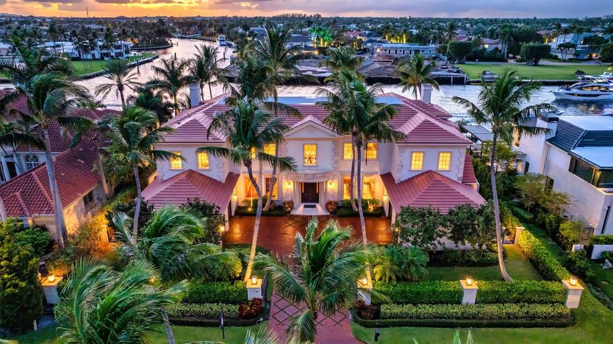 Gated Palm Beach-inspired Tropical Georgian sited on 123 +/- feet of Intracoastal with wide views overlooking Royal Palm's Grand Canal and originally built by acclaimed Frankel Estate Homes, Carlos Martin Architects, and interiors by Marc-Michaels. An elegant and graceful staircase with N/S Gallery sets the stage for this high- styled Intracoastal mansion with all public rooms facing the waterway. Grand salon with adjacent club room and pub. Modern gourmet kitchen opens to a breakfast and family room. Luxurious Primary suite features a lounge/retreat with fireplace, dual spa-like baths, walk in closets and two balconies. Outdoor entertaining is enjoyed at the elegant pool/patio, grand lanai with fireplace, separate pavilion with summer kitchen for alfresco dining. Shown by appt only