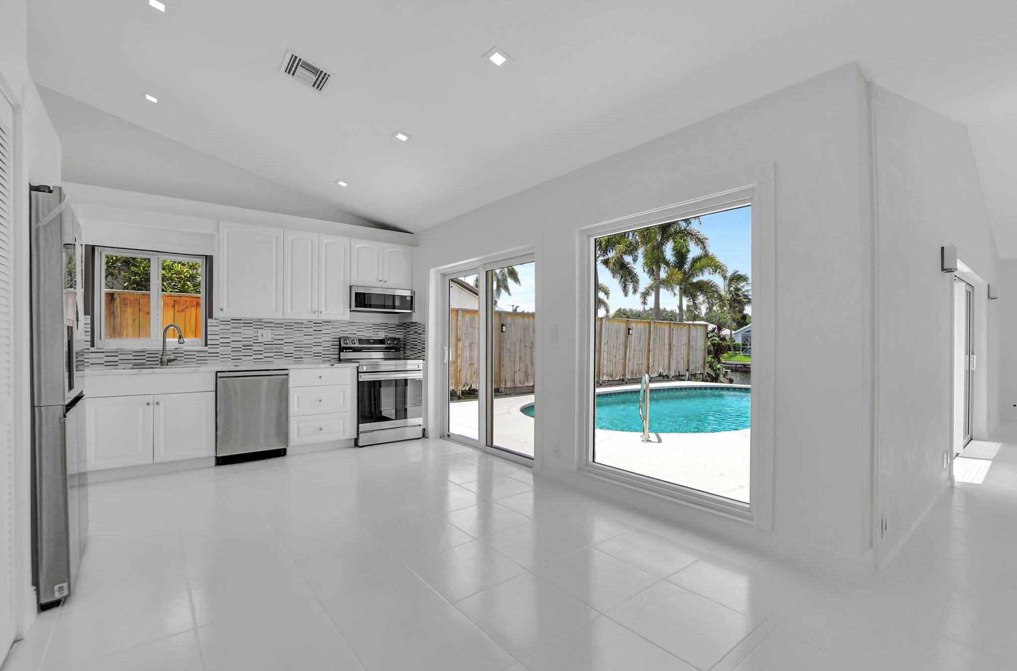 Experience the quintessential South Florida lifestyle in this East Boca Raton home. This home offers a spacious floor plan that feels like a single-family retreat. A boater's dream, it features a private pool alongside a wide canal with intracoastal access and a private dock, creating a perfect backdrop for relaxation and entertainment.Inside, vaulted ceilings and abundant natural light emphasize the stunning waterfront views. The kitchen is a chef's dream, with easy access to the magnificent pool and patio. Residents will appreciate the proximity to top-rated schools and the vibrant downtown scene. Just minutes away from sandy beaches, Mizner Park, Town Center Mall, and a variety of dining options, this residence offers the perfect blend of comfort and convenience.