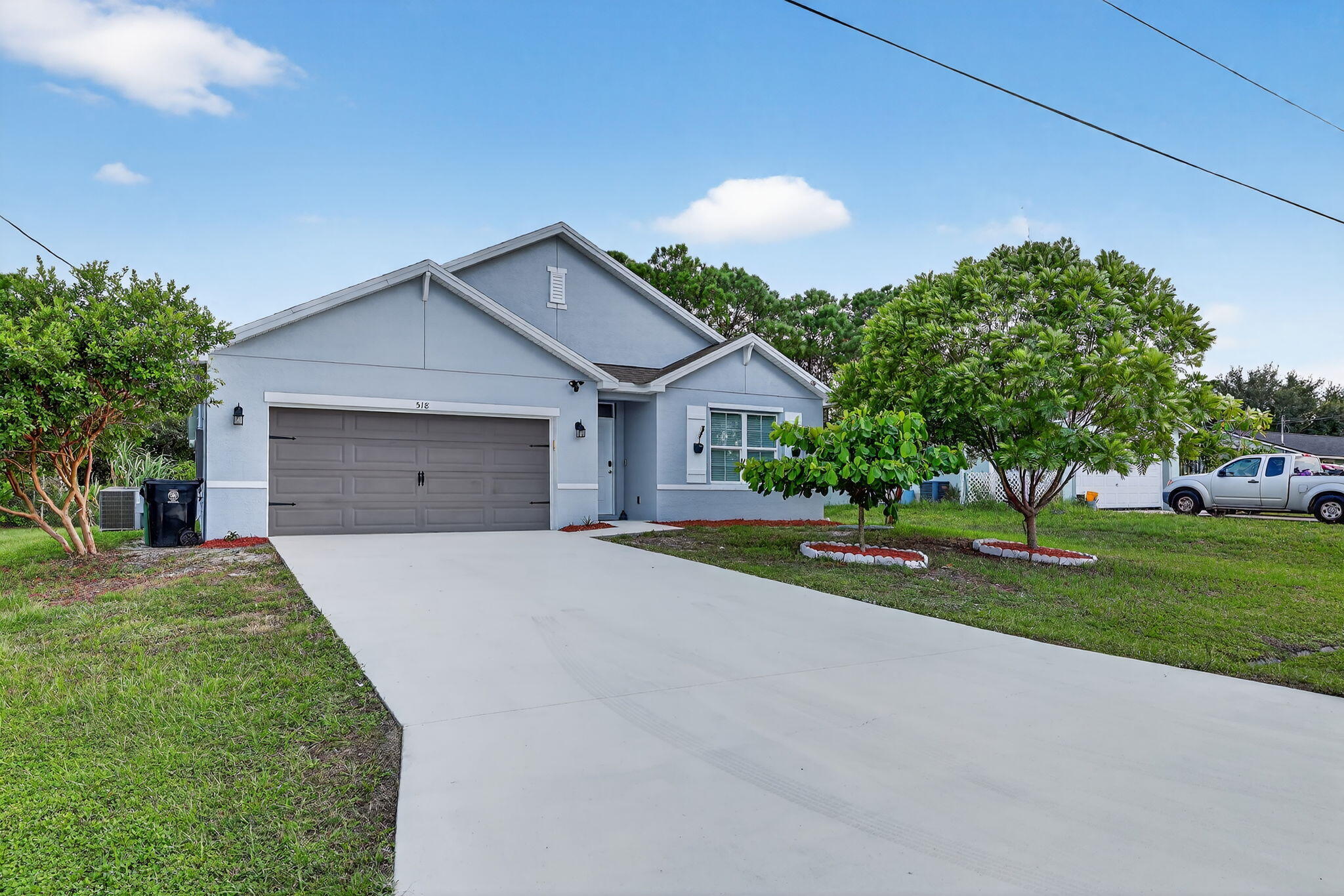 Desirable Port St. Lucie Section 9! This four-bedroom, two-bath CBS home offers 1,827 sq ft under air with a split floor plan, two living areas, and separate dining. Kitchen features a large island, breakfast bar, and stainless steel appliances. Spacious master suite with walk-in closet. 18x18 tile in kitchen, baths, and entry. Security system with Ring cameras, flood lights, and covered lanai. Newly landscaped with Mahogany, Holly, Bottlebrush, Guava, and more. Two-car garage. Excellent schools and neighborhood, close to Turnpike, I-95, shopping, and dining. Vacant and ready to show!