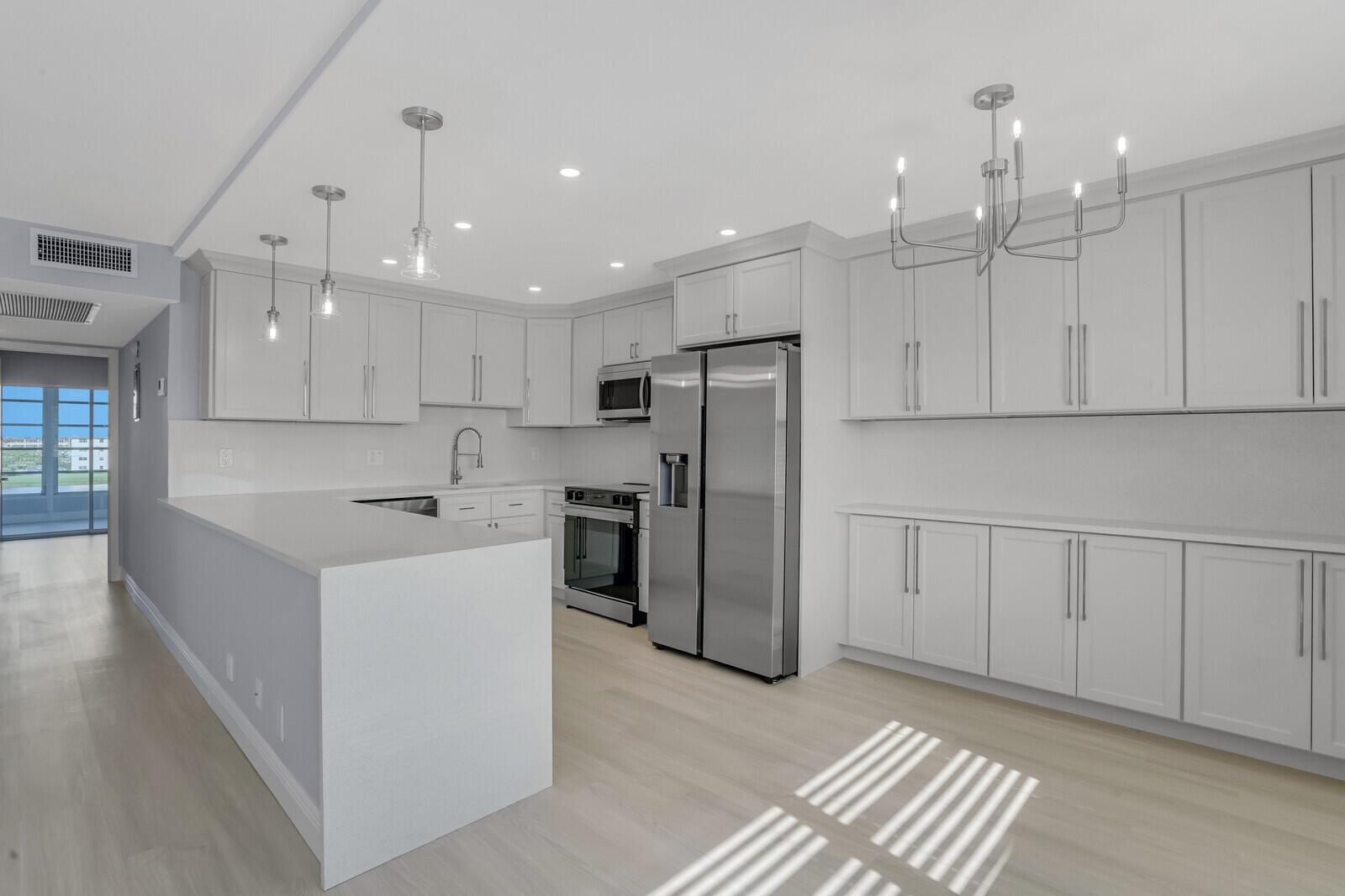 Enjoy incredible lake views from this gorgeously remodeled penthouse unit in Ainslie. Upgrades include, Luxury Vinyl flooring, expanded open concept kitchen w/ soft close cabinets, Quartz counters, Samsung appliances, double compartment SS sink, LED high hats, new fans & light fixtures. Baths have been renovated top to bottom w/ new vanities, quartz counters, new plumbing fixtures, porcelain tile walls & frameless glass shower doors. Custom shelving system installed in master closet. Amenities include internet, cable, fitness center, multiple swimming pools, movies, shows, bingo, classes, tennis, card rooms, bus transportation and close to shops and restaurant. Superb workmanship with breathtaking view. Must see!