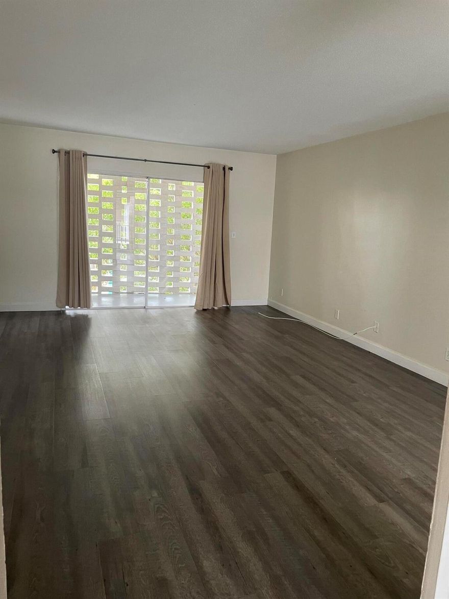 Second floor spacious 2 bed,1 bath  vinyl wood flooring throughout, freshly painted apartment. There is a large entryway leading to the living and dining area that is large and bright with a private balcony. The kitchen is off the dining area with lots of storage. The Primary bedroom has a large walk-in closet with lots of light. The second bedroom has a large closet.There is also a spacious bathroom with a tub. Nice Community pool is 10 steps away, laundry facilities in the building,1 assigned parking space and plenty of guest parking available. Plus minutes to the beach's, restaurants, shopping and airport.