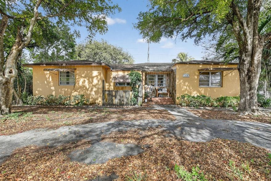 RARE DOUBLE LOT PROPERTY near the beach in highly desirable Hollywood.  Elevated above surrounding homes, this unique offering features a 3-bed/2-bath main residence plus a 1-bed/1-bath guest house with mini kitchen ideal for in law or rental inclome.  Total 2708 SF under air.  The expansive yard has a 10ft deep pool, alley access and fenced parking for an RV or boat.  Home needs updating, is sold as is and priced way below improved value.  There is plenty of room to purchase as a flip or as a rental for the guest house or for both homes.  Roof 2006 and water heater 2025.  Homes on double lots this close to the beach are seldom available.  Perfect for end users or investors alike. less than 3 miles to the beach makes this desible for full time living and/or vacation-rental income.