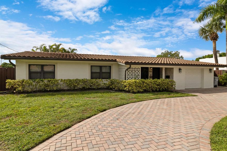Welcome to your waterfront oasis in the highly sought-after Pompano Isles neighborhood. Step inside and you're greeted by abundant natural light streaming through large impact windows, highlighting the home's modern finishes and serene view of your private outdoor retreat. This fully renovated pool home captures the essence of South Florida living, offering 75 ft of waterfrontage, no fixed bridges, and direct ocean access, a waterman's dream. Every detail has been thoughtfully updated, including a new roof and fencing (2020), a 12,000 lb boat lift (2021), a new patio roof (2021), and a new HVAC system (2023). Inside, the open-concept layout connects the living, dining, and kitchen areas, creating a seamless flow for both everyday living and entertaining. The kitchen features bar seating,