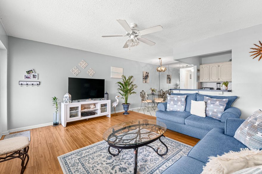 Welcome to easy South Florida living in the amenity filled 55+ community of Century Village! This bright and charming 1BR/1BA second-floor condo offers comfort and peace of mind with a NEW ROOF (2023), two newer wall A/C units (2023 & 2024), newer water heater, and NO assessments. Features include no carpet, spacious bedroom with built-in closet shelving, large walk-in storage/pantry, dining area with barstool seating, patio/sitting room with greenery views, and can be sold furnished or unfurnished. Assigned parking + guest parking. Enjoy resort-style amenities: gated security, 1,200-seat theater, pools, pickleball, tennis, bocce, sailing, clubs, and more - minutes to downtown West Palm Beach. Excellent value and ready for its next owner - bring all offers!