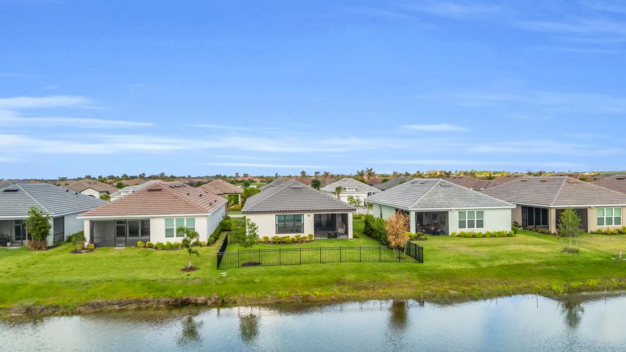 Fall in love with this Lakefront Bergamo Beauty! 10060 SW Santini is MOVE-IN READY NOW and is highly upgraded! This spacious beauty offers 2 large bedrooms plus flex-room and is centrally located on a street that has no more construction on larger lot! Receive peace of mind with friendly neighbors, fenced yard, cameras. This beauty was built in 2024 and feels like a model! UPGRADES INCLUDE: Impact windows & custom front door, Whole-Home HVAC U/V Filtration system, custom chandeliers, designer curtains, beautiful wallpaper, built-in closet shelving, remote control blinds, shower water filtration, tankless water heater, gas stove, Samsung refrigerator w/ interchangeable panels, epoxy garage floor, tinted glass for privacy, Clearview patio screening, fenced backyard.