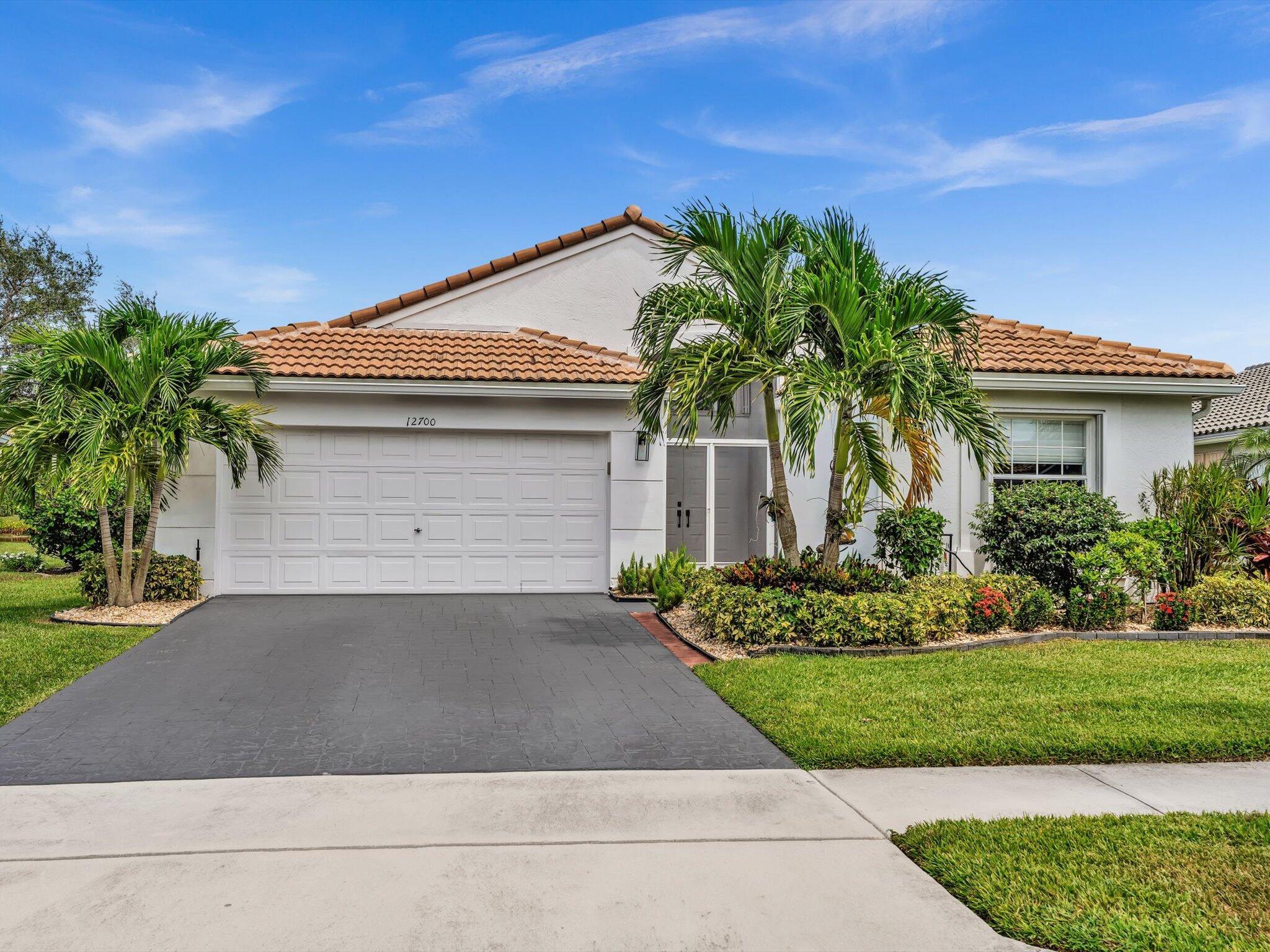 FULLY RENOVATED Grand Palm model with NEW ROOF situated on one of Regency Cove's S.E. exposure lakefront lots offering SPECTACULAR views! The 3/2 open floor plan features 2,187 sq. ft of luxurious living and was remodeled in late '22/early '23. The long list of features & improvements includes porcelain wood-plank flooring throughout, custom built-in's, island kitchen with shaker cabinetry, modern hardware & pull-outs, quartz counters/backspashes, custom hood and upgraded LG stainless appliances. Both bathrooms & laundry room boast quartz counters, shaker cabinetry & frameless showers - with primary bath equipped with free-standing soaking tub! A Florida Room provides year-round enjoyment of the outdoors while protecting from the elements. New AC in '23 & full accordion storm protection!