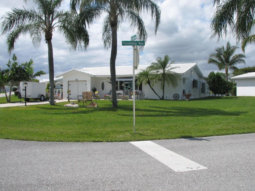 Spectacular Expanded Challenger on a corner lot with open floor plan 2 Bedrooms, 2 Baths, Large Florida Rm 43x12, Lani 43x10 Slider doors throughout the home. Beautifully updated. Nice lot with a great lake view in this 55+ community of Boynton Leisureville. Attached garage. Paid Rec Lease. Pet Friendly community with active Clubhouse, Pool Golf and More! All measurements are approximate.