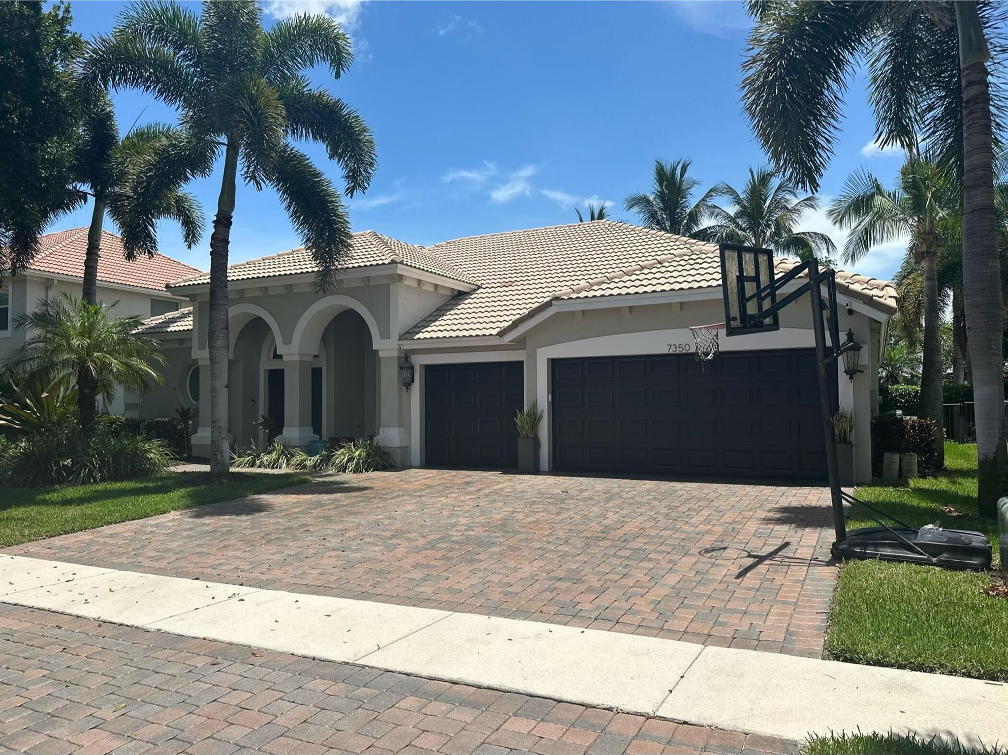 Stunning 4 bedroom, 3 bath single-family, ranch style pool home with 3 car garage situated on an estate-sized lot in a boutique community in Delray Beach. This well maintained residence features an upgraded kitchen with custom cabinetry, high-end appliances, and quartz countertops. Beautiful wood floors flow throughout the main living areas. Impact windows and doors, split floor plan that offers a spacious primary suite with walk-in closets and a luxurious en-suite bath. Three additional bedrooms and two full baths on other side with two brand new AC units. Open concept living and dining areas. Interior laundry room and generous storage throughout. Originally double-stuccoed for enhanced insulation and offers superior climate control and remarkably low utility bills year round. Located on