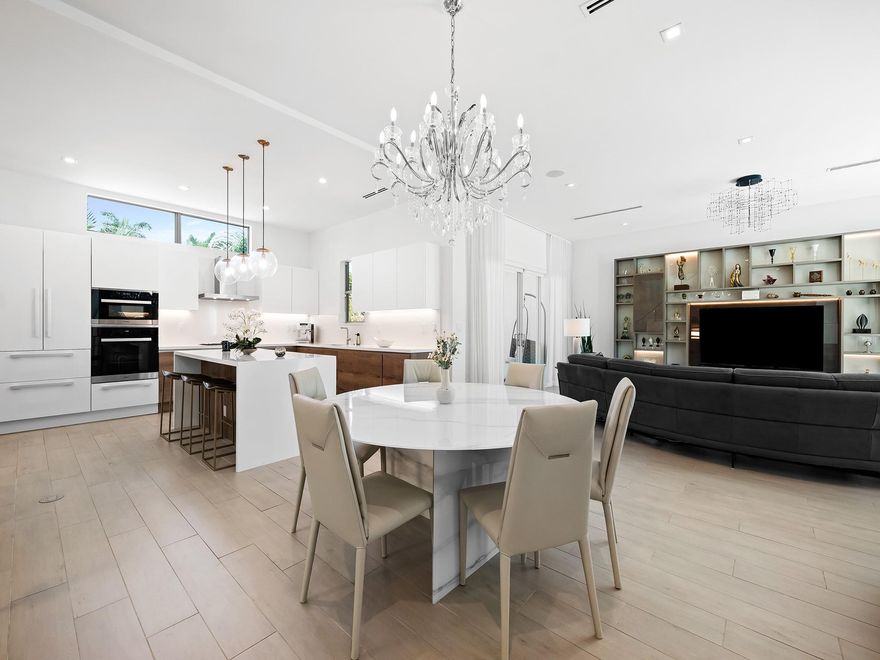 Welcome to this exquisite townhome, where luxury meets tranquility. This  residence features two primary suites, including one on the 1ST floor, each with walk-in closets and dual sink vanities. With three bedrooms and three-and-a-half baths, this home emphasizes comfort & functionality. Step outside to a private oasis with a screened-in patio, outdoor kitchen, and private pool. Natural light floods the living spaces, enhanced by sliding glass impact doors and windows. A private elevator ensures easy access to all floors. The custom kitchen delights with designer cabinets, elegant countertops, and premium appliance package. Highlights include large ceramic tile floors, glass railings, and stunning ceiling details with designer light fixtures.(FURNITURE NEGOTIABLE). Sq Ft based on BCPA.