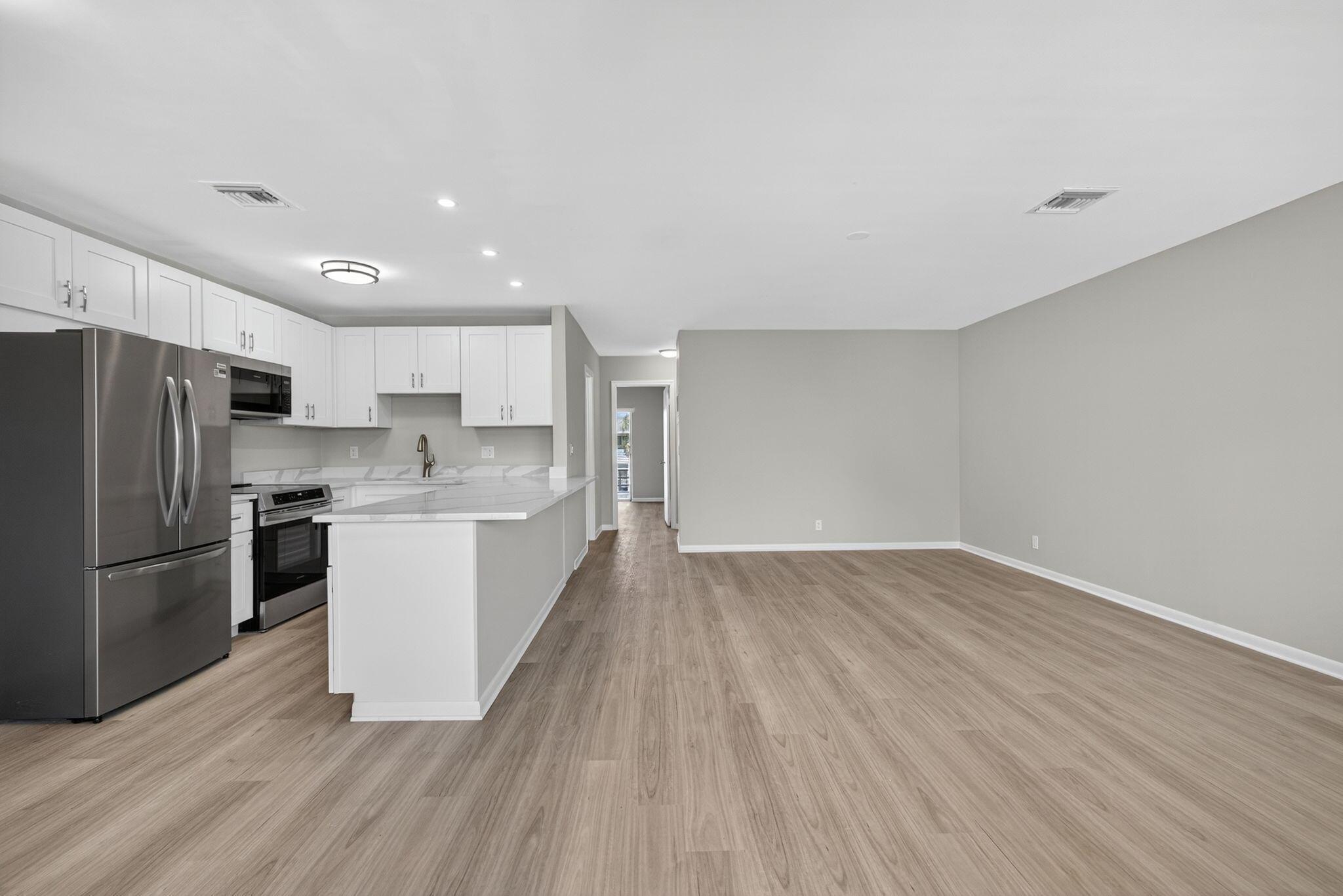 Stunning Fully Renovated Condo in Premier 55+ Community ~ Step into luxury with this beautifully renovated 2-bedroom, 1-bath condo showcasing high-end finishes throughout. From the moment you enter, you'll appreciate the sophisticated open design, featuring top-tier woodgrain plank laminate flooring that seamlessly flows through every room. The open-concept kitchen with separate dinette area is a showstopper, offering brand-new stainless steel appliances, custom cabinetry with gleaming quartz countertops, and a spacious island--perfect for entertaining or casual dining. The bathroom has designer tile with a modern vanity and light fixture. The open and airy layout is bathed in natural light, enhancing the serene, upscale atmosphere of the home. Located in one of the area's most​​‌​​​​‌​‌​​​‌‌​​​‌‌‌​​‌​​‌‌​​​​ desirable
