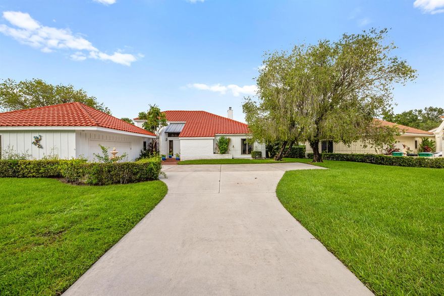 Welcome to this spacious 3-bedroom, 3-bath home in the gated Meadowood community, offering comfort, privacy, and scenic golf course views. The open living and dining areas feature soaring ceilings, transom windows, and a fireplace that creates a warm focal point. The kitchen is beautifully upgraded with modern finishes, and each bedroom enjoys its own en suite bath, including a private upstairs suite. Sliding doors lead to a screened wraparound porch overlooking the first fairway, perfect for relaxing or entertaining. Additional highlights include new flooring throughout, two air conditioning units (1 brand new), and an oversized two-car garage with room for a golf cart. Conveniently located near I-95 and the Florida Turnpike.