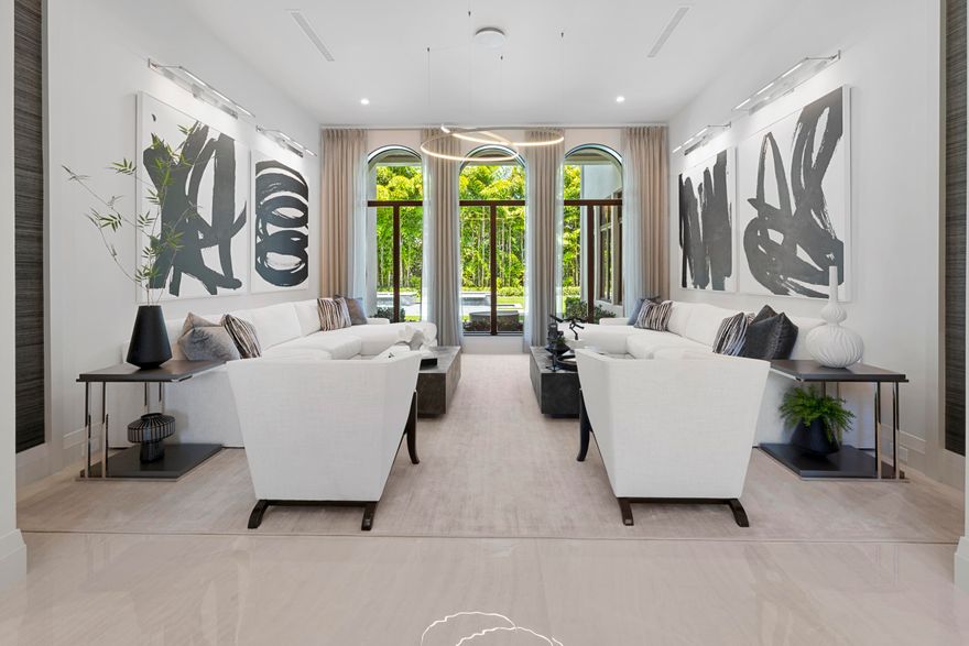 Experience luxurious living in this custom-built residence by Estate Development boasting award winning interior design firm P&H Interiors. 
This sprawling estate underwent an extensive renovation, reimagining every detail from the interior and exterior to the outdoor landscaping and grounds.  This estate features 8 bedrooms, 9 full bathrooms, 3 half baths, a gourmet chef's kitchen, home theatre, office, loft, impact windows and doors, a circular driveway and 3 car garage. As you enter through the grand double-door entry into the foyer with 23 foot high ceilings you will be captivated by the exquisite design and architectural details of this one of a kind property. A floating glass and wood staircase, a barrel ceiling in the dining room, porcelain and wood floors, and dual islands in the kithchen, no detail was spared. An oversized family room is drenched with natural sunlight and overlooks the covered patio and backyard. The expansive master suite boasts his and her bathrooms and dressing rooms. Enjoy the Florida sunshine in your own private outdoor oasis. Heated salt water swimming pool, oversized spa, cascading fountains and an expansive covered patio complete with an outdoor kitchen. As you make your way upstairs, you are greeted by a show-stopping office, a comfortable movie theater for the family, and a separate loft area with 6 en suite bedrooms, providing ample space for privacy and relaxation. This home is located in the Devon Place subdivision of Woodfield Country Club, a private but active country club community that is centrally located and offers a multitude of high-end amenities that make the South Florida lifestyle so remarkable.