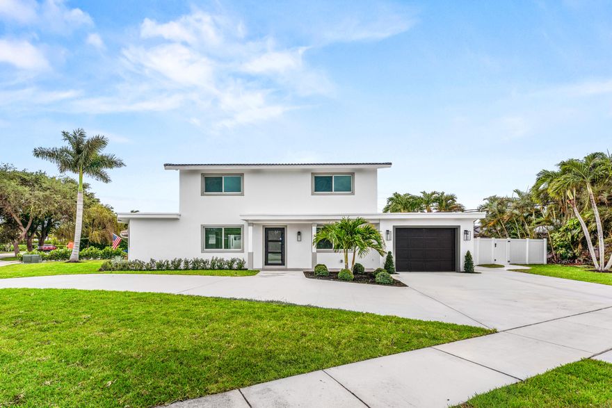 This stunning, remodel, complete with impact glass and a new circular driveway, totally captures the Florida lifestyle! First floor, designed with porcelain tile, blends with warmer tones of the large kitchen area. From the stainless steel appliances to the huge, quartz waterfall island, this kitchen promotes social connection with its open flow to the dining area, with clear views of the family/living room and out through the sliding doors to the vast, pool area.  New resurfaced pool and new tiled pool deck. The first floor bedroom, complete with bathroom and entrance through to the garage is perfect for the college student. Upstairs are 3 additional, light, bright and sunny bedrooms with modern bathrooms and luxury vinyl flooring. In East Boca and top rated school district location.