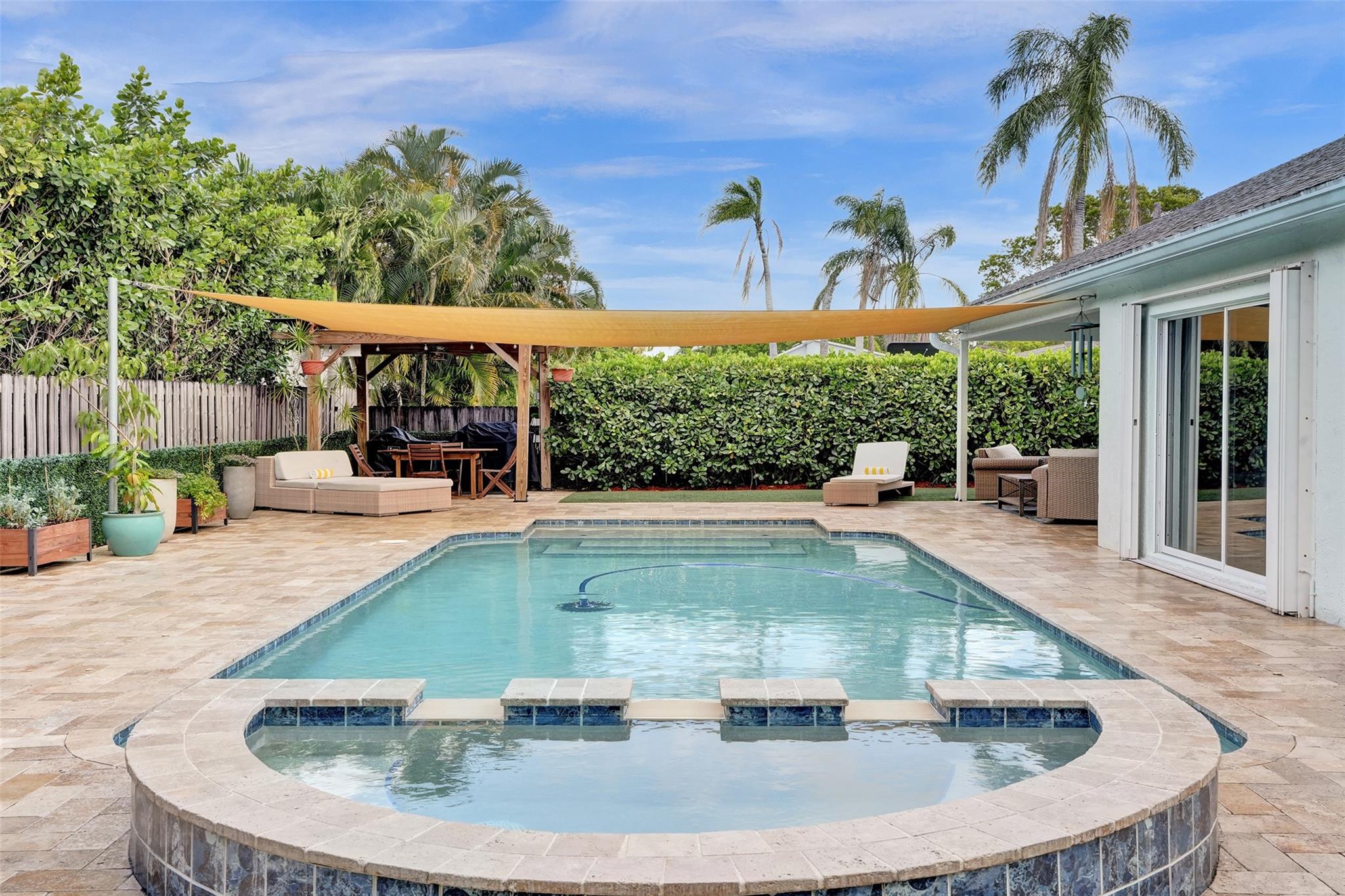 Ready to trade your hustle for hammock time? Say hello to your laid-back FL lifestyle in this Cooper City gem — 3-bed, 2-bath pool home plus a den/office (because even paradise needs a Zoom corner) or make it 4th bed. You’ll be greeted by vaulted ceilings, open living & dining areas, & a crisp white kitchen with granite counters & shiny stainless appliances just begging for brunch. And the upgrades? spa-worthy bathrooms, impact garage door, & a backyard that makes others jealous. Pool+Jacuzzi have child fencing, accordion shutters all around. Tucked in the oak-canopied charm of Cooper's Place, this is the one you’ve been manifesting. Come see it before someone else claims your pool float.