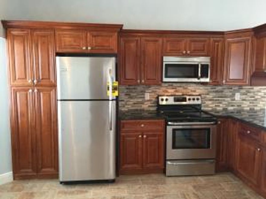 This Spectacular 2/2 Single Family Home has been completely gutted and completely remodeled. EVERYTHING IS NEW! New AC, New Kitchen, New Bathrooms, New Flooring, Freshly Painted inside and out including garage and garage floor, New Custom built in closets, New Doors, New Closet Doors, New Landscaping, Fenced in Yard (PETS WELCOME!)  Everything is so new YOU get to take the plastic off!  don't let this one pass you by!