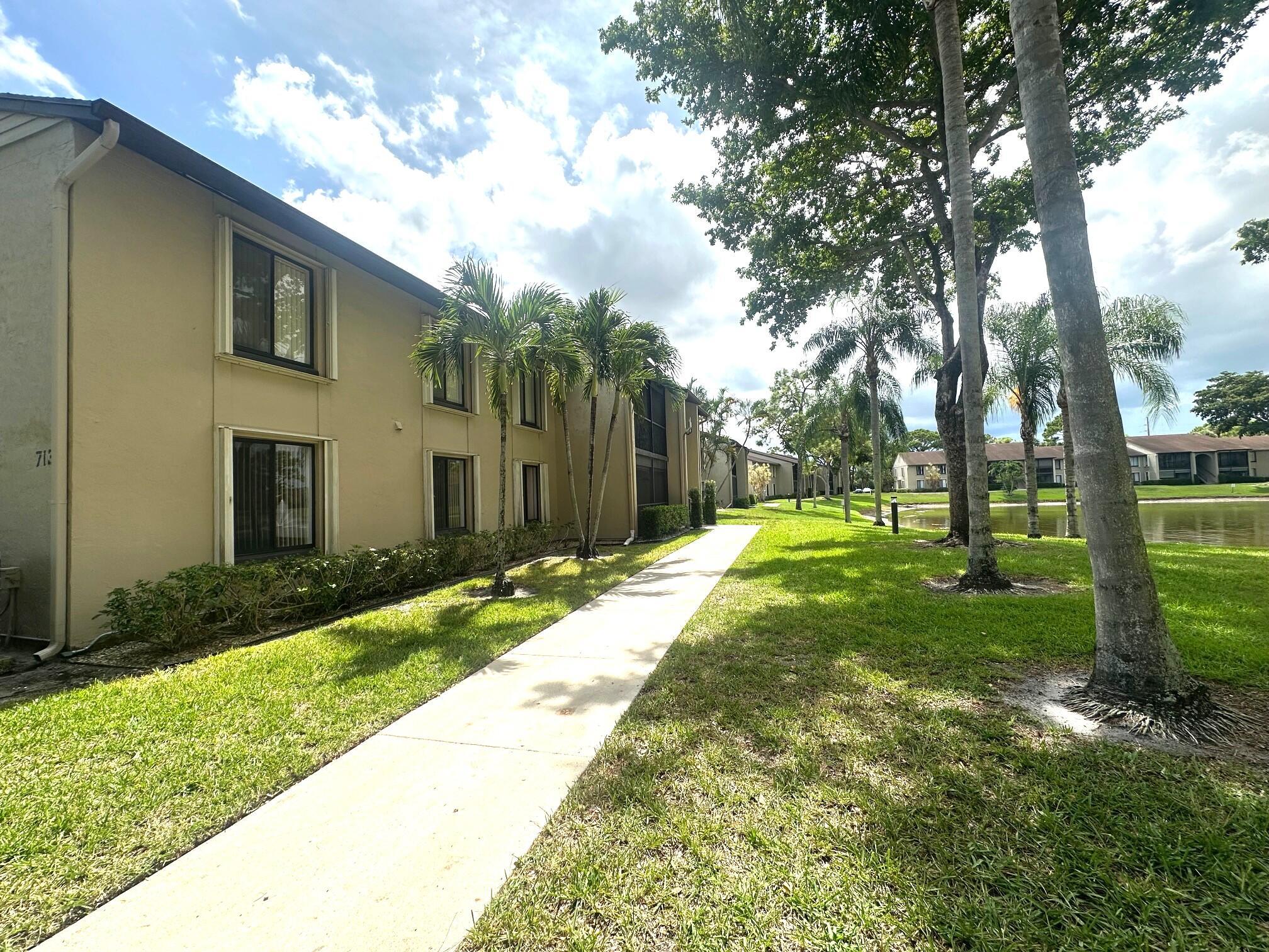 ALL AGES WELCOME! Lakefront corner condo. This charming 1st-floor unit with serene lake views & screened patio perfect for relaxation. Featuring 3 spacious bedrooms and 2 full bathrooms, features kitchen with granite countertop, extra cabinets and in-unit washer/dryer. Condo fee includes exterior building insurance, maintenance, cable, and access to community amenities. 2 VEHICLES MAX, 1 PET w/25 lbs. Ideally located near Publix shopping center, restaurants, parks, top-rated schools, Wellington Mall, and just minutes from the airport. Enjoy easy access to I-95 and the Turnpike for a smooth commute. Conventional financing available with as little as 3% down--a fantastic opportunity for first-time buyers or 2nd seasonal home. Priced to sell quickly--don't miss out!