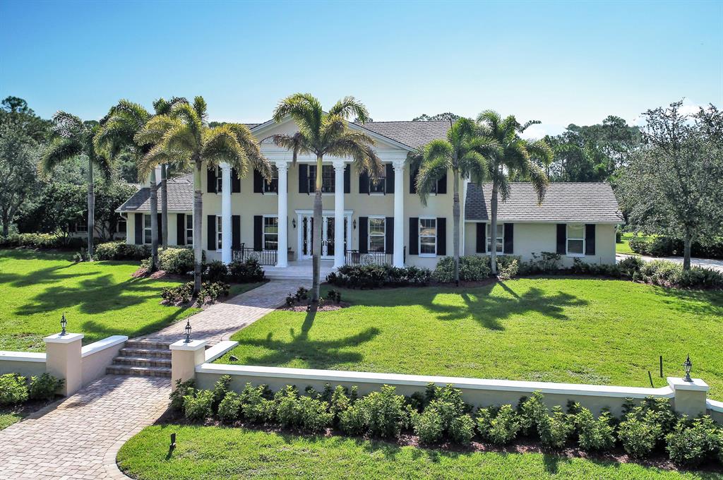 If you are looking for convenience and privacy you have found paradise. This 12 acre estate nestled in the premier equestrian area of Palm City Farms features a plantation style 7,466 sq. ft. home offering both formal and family living, chefs kitchen, elegant dining room and outdoor living are perfect for lazy days at home or entertaining. In addition to imported marble, custom millwork, and tri-level cascading pool you are close to schools, shopping and both the Turnpike & I-95. If you prefer to fly property has access to lighted runway and has a private hanger with A/C, office, and bath.