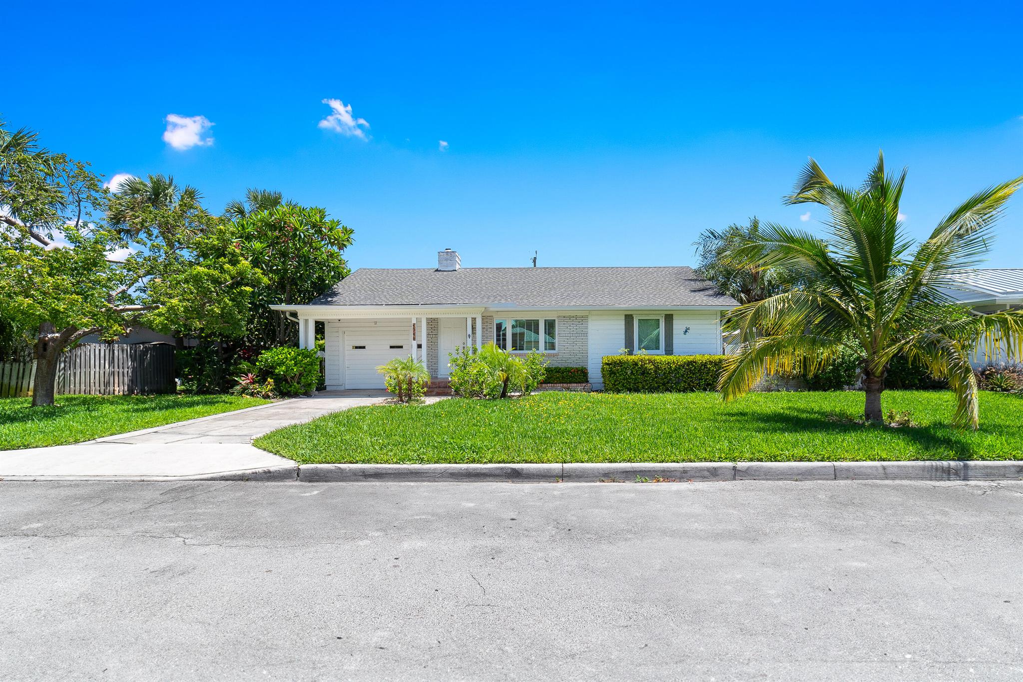 Experience the Key West vibe on a DOUBLE lot, just steps from the water where the salty air greets you daily. This charming home captivates from the curb, inviting you inside where warmth and comfort await. Enjoy wood and tile flooring, a cozy fireplace, and built-in bookshelves that add character and charm. Both bedrooms are generously sized, with two full baths, including one fully renovated. The kitchen offers stainless steel appliances and crisp white cabinetry. Outdoors, the fenced yard provides room for a pool, while the Florida room with louvered shutters opens to a sun soaked relaxing patio--offering the perfect option for sun and shade year-round. No HOA fees or restrictions. Mortgage savings may be available for buyers of this listing.