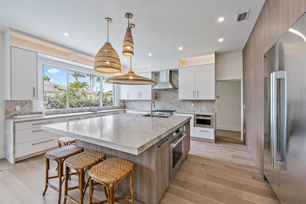 Light filled 4 bedroom, 3 full bathrooms + powder room (plus office/den/5th bedrm) home has been completely reimagined and re-built in every possible way. The centerpiece of this coastal, chic property is the fabulous chef's kitchen with gas stove, refrigeration columns, double ovens, 2 sinks, huge island with honed quartzite countertops overlooking the brand new swimming pool and spa. Split master suite features large walk-in closet, access to pool and patio, 2 vanities, large shower and tub. All impact rated openings & new metal roof. High-end finishes that are a must see! Centrally located in SoSo near restaurants, shopping, Palm Beach, Kravitz Center and PBI airport. Garage is finished with a/c, drywall, led lighting, epoxy floor & Clopay door. This construction project is brand new