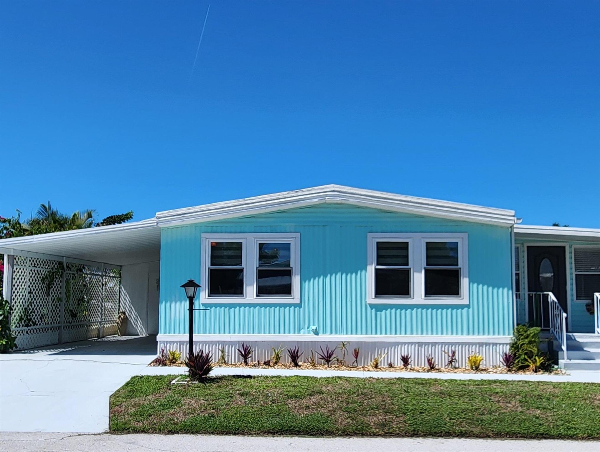 FULLY REMODELED & MINI GREEN for PETS at this 2 bed/2 bathroom beauty where SAFETY FEATURES merge w/ SOPHISTICATION. Don't miss this home which outshines the rest! BUILT FOR STRENGTH &SOPHISTICATION. LIST OF NEW Items includes but not limited to:DOUBLE HUNG, IMPACT WINDOWS w/ CUSTOM SHADES, SUBFLOORING w/ LUXURY VINYL PLANK FLOORS, DRYWALL, ENTIRE KITCHEN, APPLIANCES, ENTIRE MASTERBATH, Pantry w/ PULL-OUT drawers, CUSTOM DOORS, HAND CRAFTED STONE MIRROR. Fully enclosed Florida Rm doubles as den/extra bedroom/home office. AC 2020. ROOF Painted & SEALED 2024. Fireplace & 60''TV STAY. Stone Patio perfect for lounging/hosting & Grass area perfect for PUPS! Active 55 + community - Lot Lease of 765 incl trash, Clubhouse, fitness, game room, pool, hot tub, library, billiards & more!