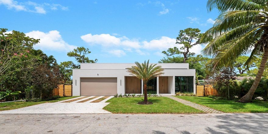 This newly built move in ready one story contemporary luxury masterpiece designed by Carla Guilham located on a generous lot boasts an impressive open floor plan with 14 FT ceilings, floor-to-ceiling windows & trifold doors allowing abundance of natural light. The zen hallway offers a sanctuary to each ensuite bedroom. Chef's Paradise kitchen features Jennair appliances, Italian cabinetry, huge Island & Quartz countertops. This house is adorned with stunning wallpaper, frameless doors, wood panels, ultra sexy interior lighting, wine room, a glass room overlooking the whole living area adding to its allure &  sets a new standard of high-end living in Wilton Manors. Enjoy your Hampton style private pool from every room while transporting you to your own Bali escape.