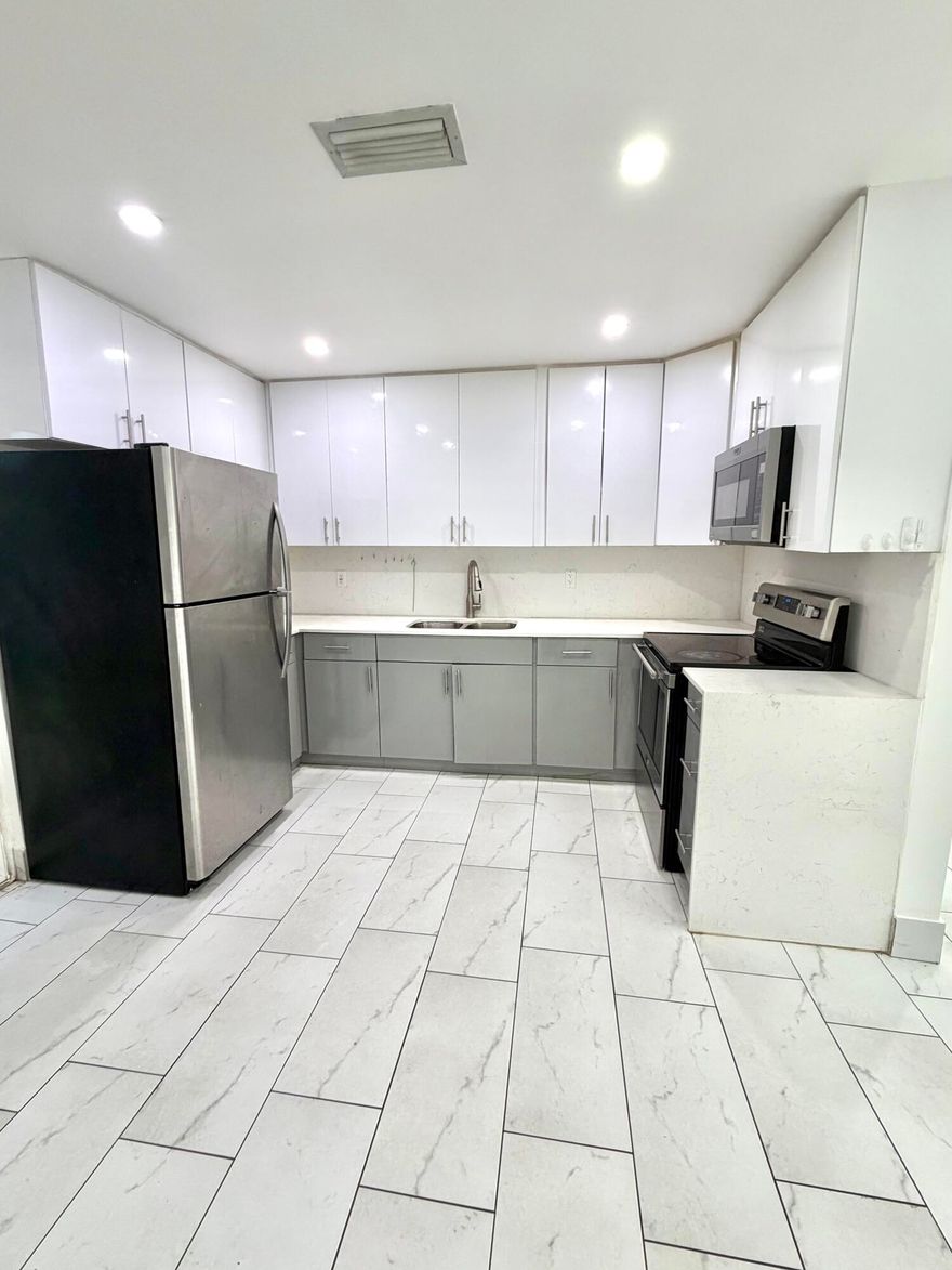 Beautifully Renovated 2 Bedroom Rental in Dania Beach    Spacious and fully updated 2 bedroom, 1 bathroom residence featuring a bright open layout and modern finishes throughout. This light-filled unit offers large format porcelain tile flooring, recessed LED lighting, fresh neutral paint, and an updated contemporary kitchen with sleek cabinetry, quartz-style countertops, and stainless steel appliances.  Enjoy generous living space ideal for comfortable everyday living or entertaining, along with ample closet storage in both bedrooms and a stylishly renovated bathroom with glass shower enclosure and modern vanity.  The property also features central A/C, impact-style windows and doors, and access to outdoor green space, creating a clean and inviting living environment. Conveniently located near major highways, shopping, dining, Fort Lauderdale Airport, beaches, and Hard Rock area.    Fast approval   Professionally maintained property   Move-in ready  Ideal for tenants seeking a modern, clean rental in a convenient central location.