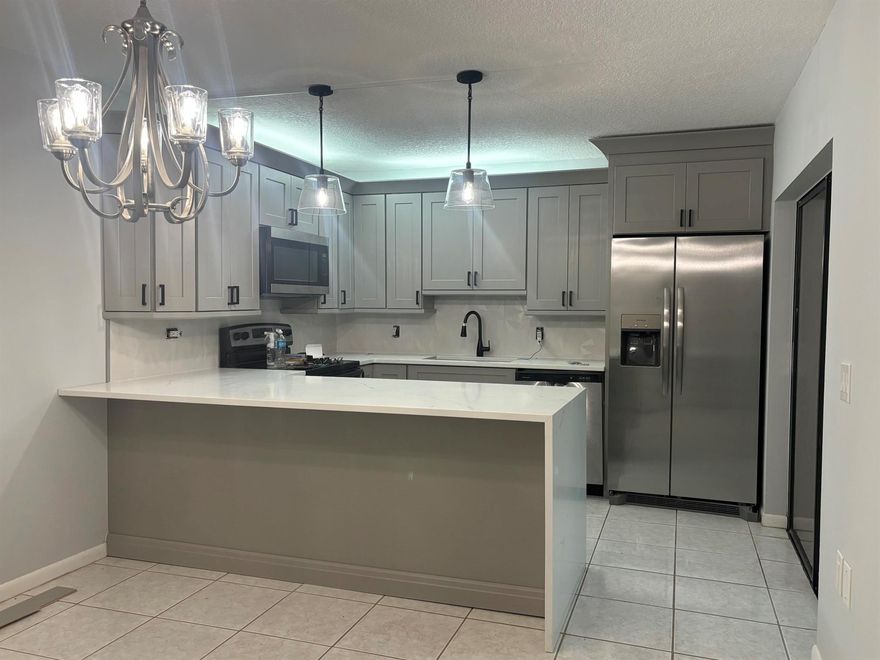 HURRY and be the first to live in this tastefully renovated townhome.  Large two bedroom PLUS den.  Wonderful kitchen with SS appliances, new cabinets, quartz counter and more. Brand new 2 full and 1/2 bathrooms.  Super large fenced patio perfect for outdoor entertaining ,and grilling.. Storm shutters. Two reserved parking spaces and plenty of guest parking. Recreation area includes tennis, basketball, racquetball, and playground. Fantastic Palm Beach Gardens location close to many shops, restaurants, and major roadways. Monthly interior and exterior pest control included. HOA does not allow pickup trucks, motorcycles, or commercial vehicles. Small dog considered at landlord discretion. No Cats.