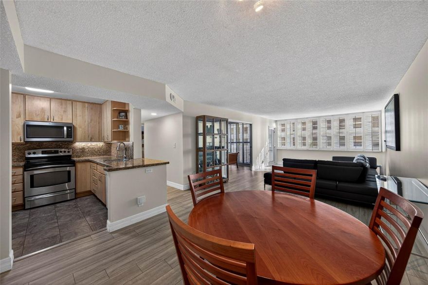 Discover sophisticated urban living in this meticulously updated 2BR/2BTH condo at East Point Towers. The interior features luxury vinyl tile, neutral tones, and impact glass with custom plantation shutters. A gourmet kitchen boasts light wood cabinetry, granite counters, SS appliances, and a coffee bar. The primary suite offers a walk-in and a gentleman’s closet.Enjoy south-facing balcony views and resort-style amenities: a gym, heated pool, new dock, and community rooms (card, library, party). Low fees include fiber-optic internet/cable and 24-hour security. Includes garage parking, guest spots, and a car wash. Ideally located near Las Olas, beaches, and the Galleria in a walkable community close to the airport and hospitals.