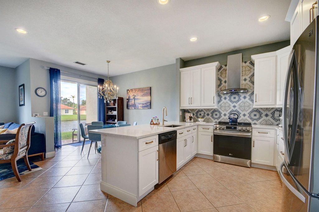 Photo of 6147 Seminole Gardens Circle, Riviera Beach, FL 33418 (MLS # R10938581)